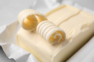 Photo of Tasty butter and curls on table, closeup