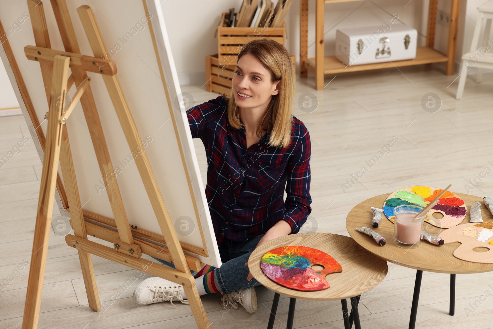 Photo of Beautiful woman painting in studio. Creative hobby