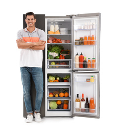 Photo of Man near open refrigerator on white background