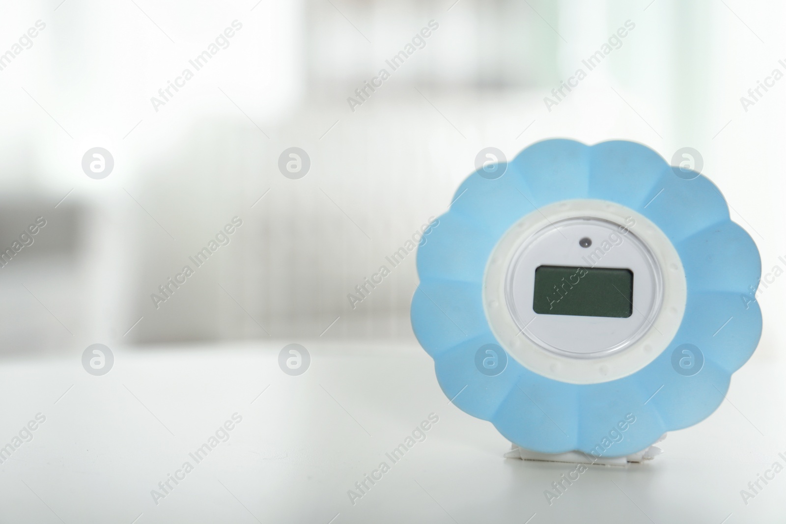 Photo of Digital temperature and humidity control in baby room interior. Space for text