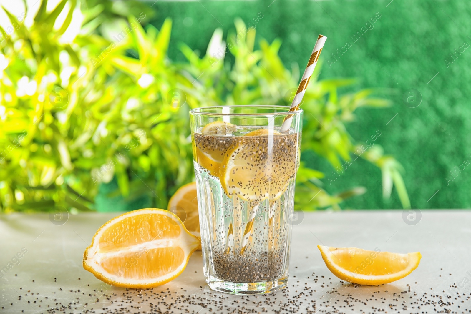 Photo of Glass of water with chia seeds and lemon on table