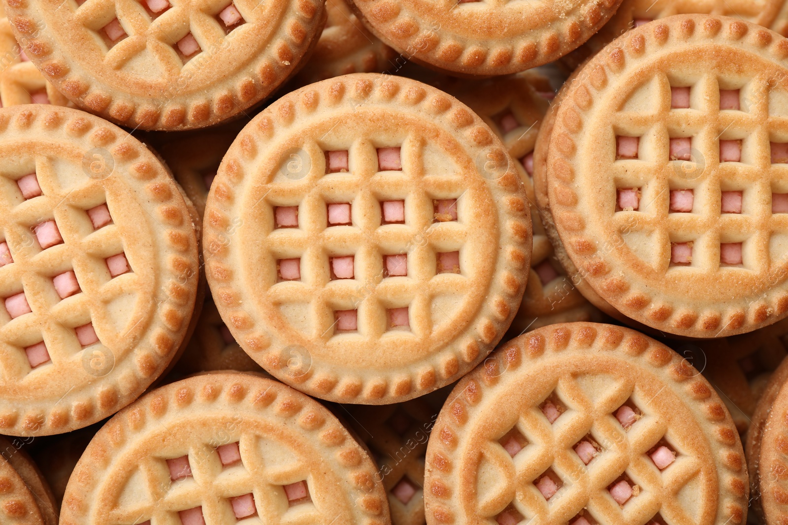 Photo of Tasty sandwich cookies with cream as background, top view