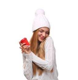 Photo of Portrait of young woman in stylish hat and sweater with coffee paper cup on white background. Winter atmosphere