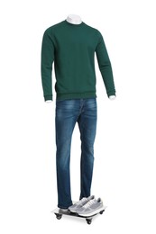Photo of Male mannequin with shoes dressed in stylish dark green sweatshirt and jeans isolated on white