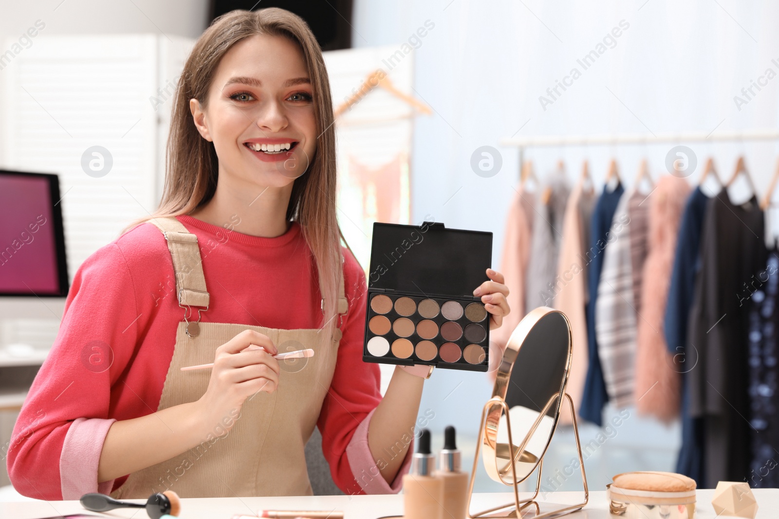 Photo of Beauty blogger with brush and eyeshadow palette at home