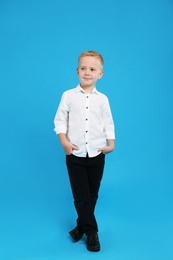 Photo of Full length portrait of cute little boy on light blue background