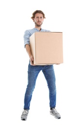 Full length portrait of young man carrying heavy cardboard box on white background. Posture concept