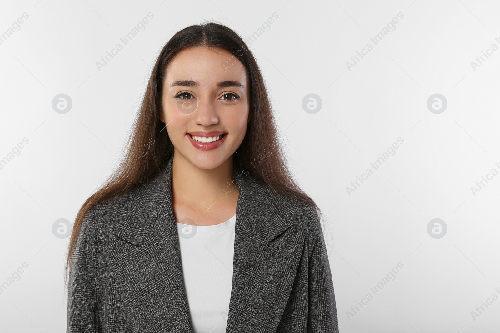 Photo of Portrait of happy young woman in stylish jacket on white background. Space for text