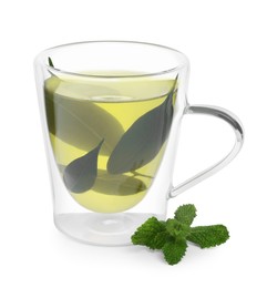Photo of Fresh green tea in glass mug, leaves and mint isolated on white