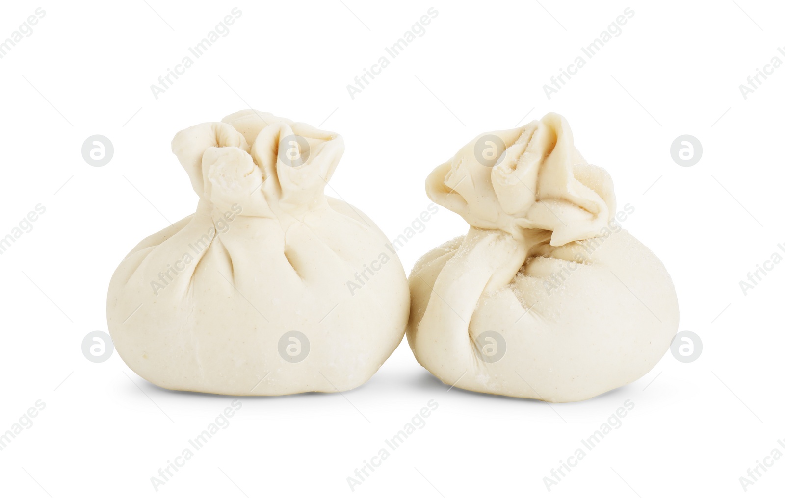 Photo of Uncooked khinkali (dumplings) isolated on white. Georgian cuisine