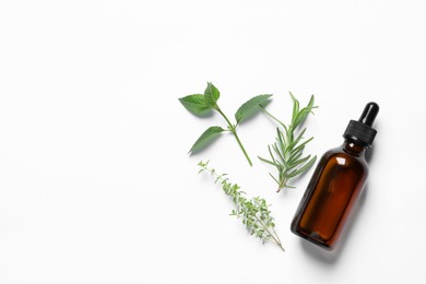 Bottle of essential oil and different herbs on white background, flat lay. Space for text