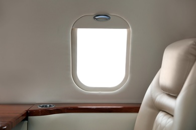 Image of Airplane cabin with comfortable seat and table