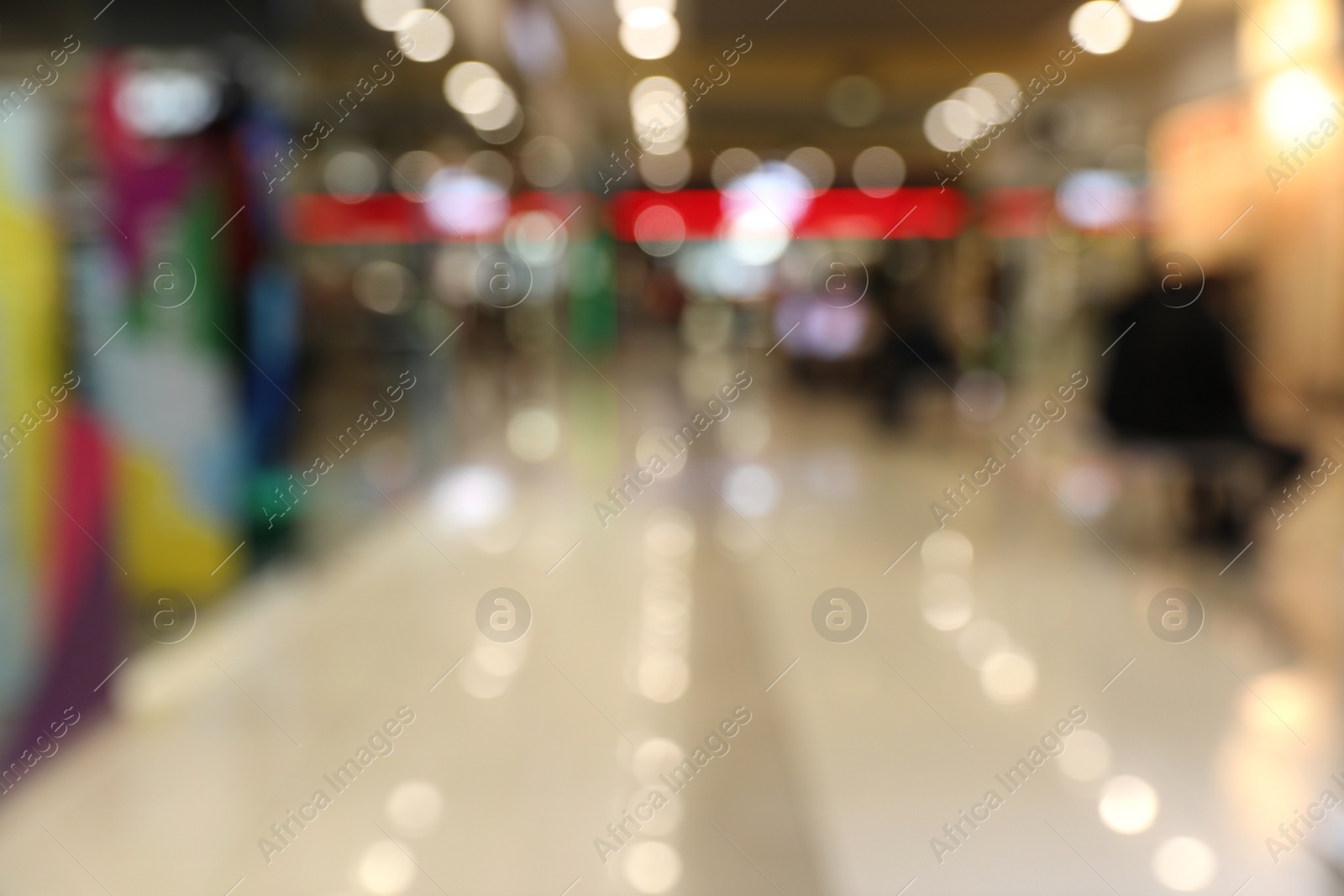 Photo of Blurred view of modern shopping mall interior. Bokeh effect