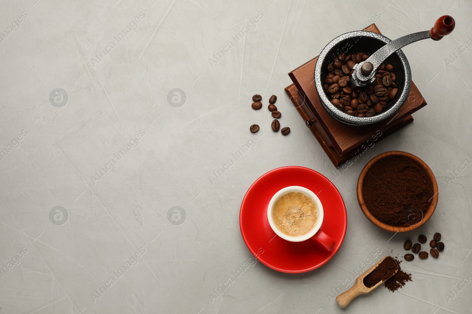 Photo of Flat lay composition with coffee grounds and roasted beans on light table, space for text