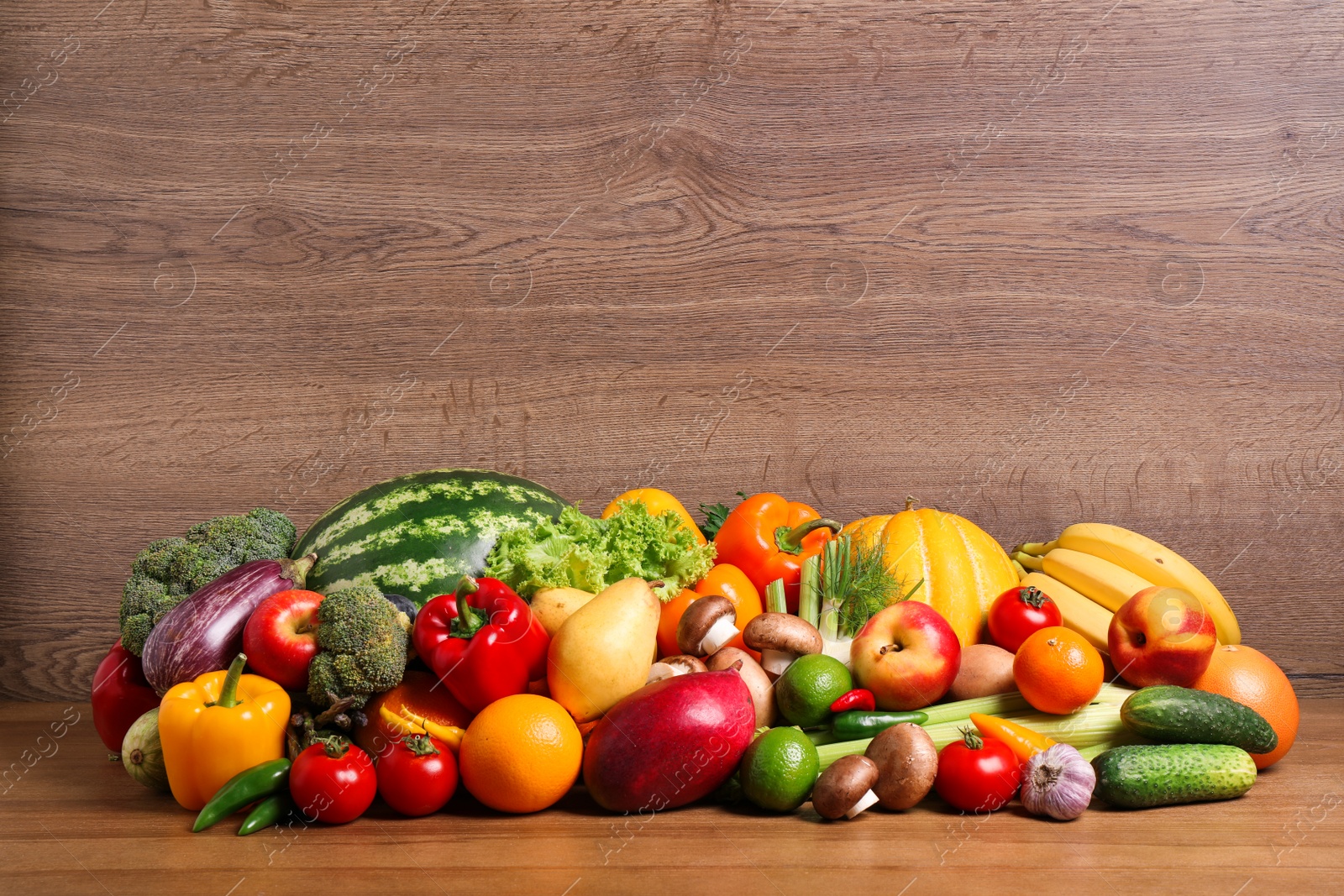 Photo of Assortment of fresh organic fruits and vegetables on wooden table. Space for text