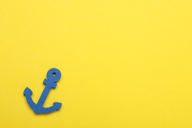 Anchor figure on yellow background, top view. Space for text