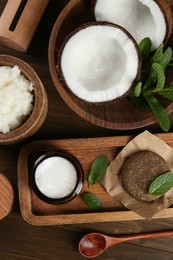 Flat lay composition with homemade cosmetic products and fresh ingredients on wooden table