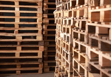 Image of Many empty wooden pallets stacked in warehouse