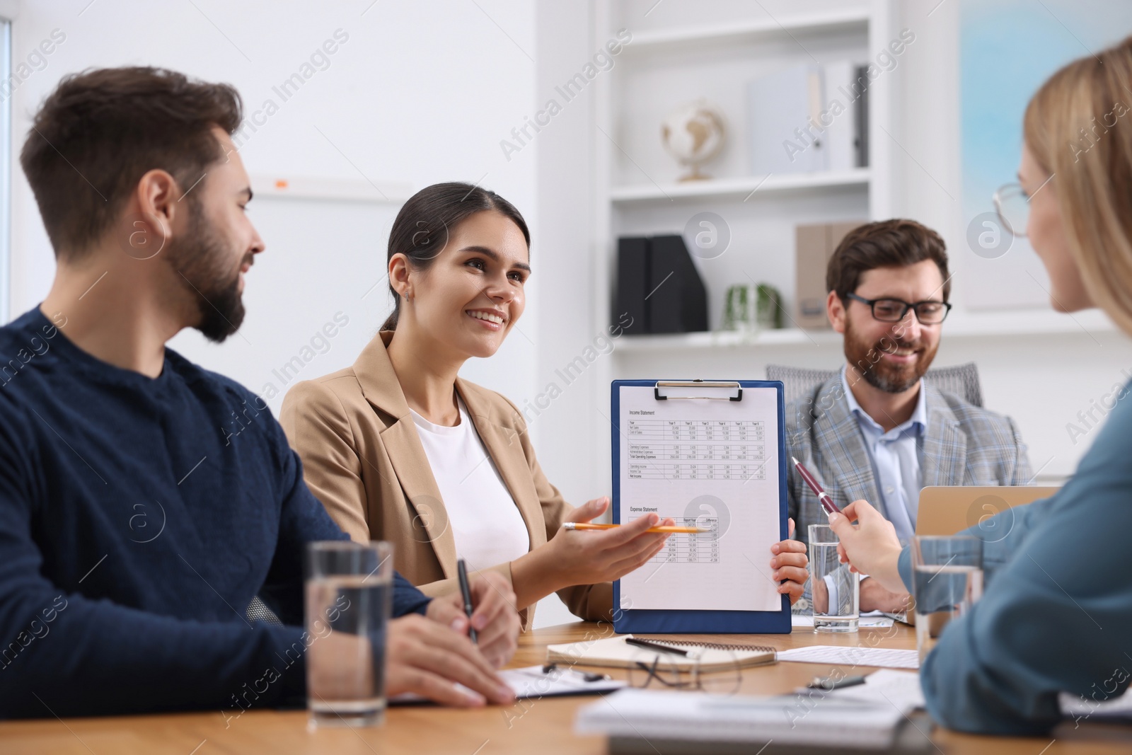 Photo of Team of employees working together in office