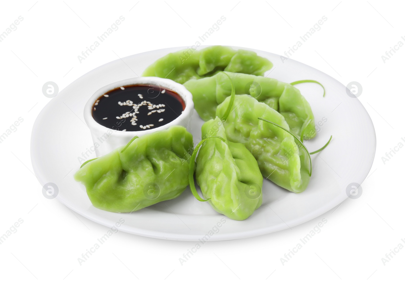 Photo of Delicious green dumplings (gyozas) and soy sauce isolated on white