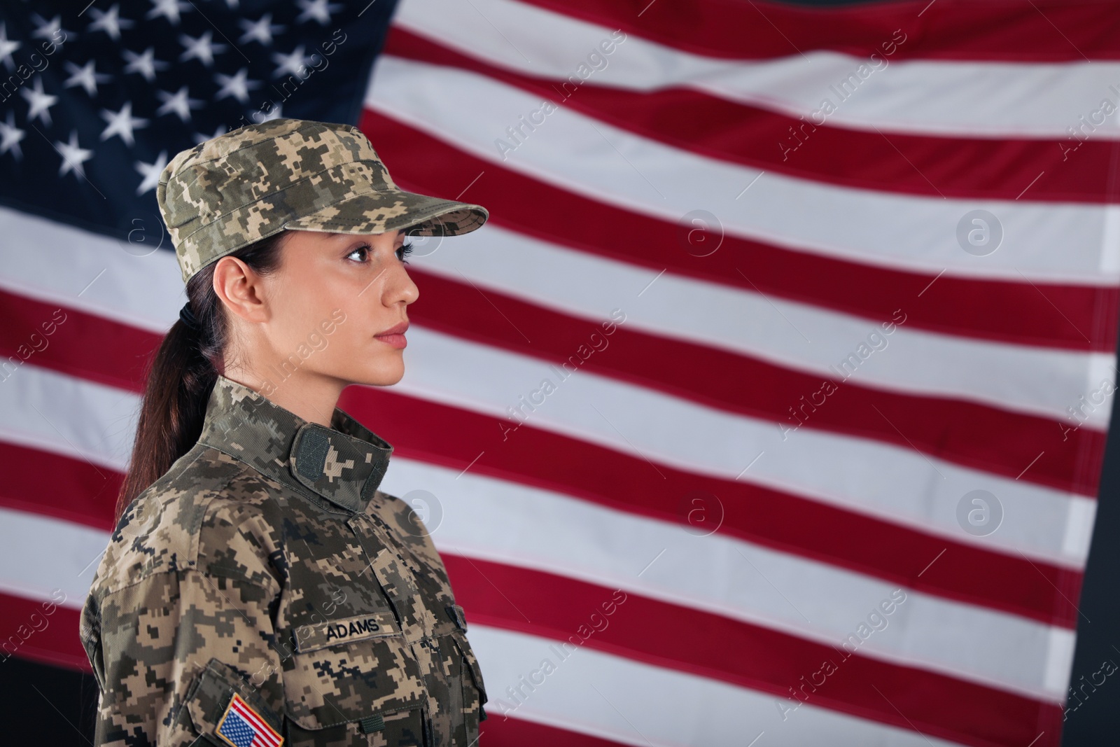 Photo of Female American soldier with flag of USA on background, space for text. Military service