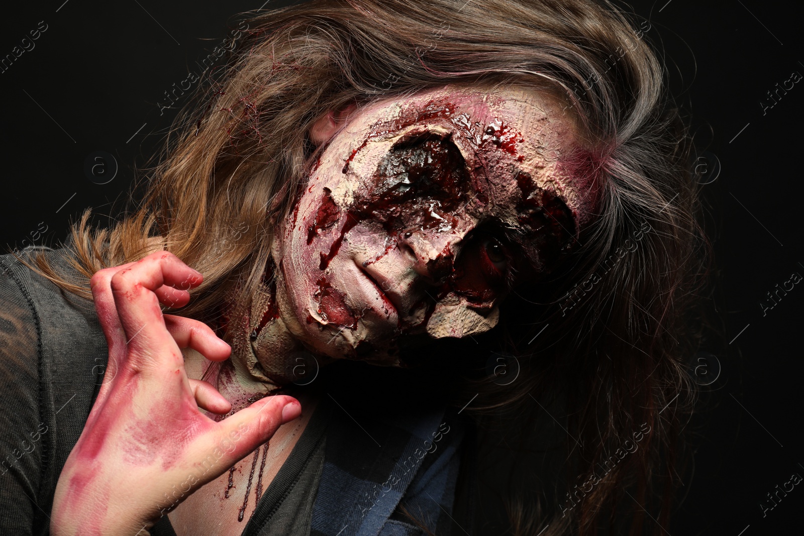 Photo of Scary zombie on dark background. Halloween monster