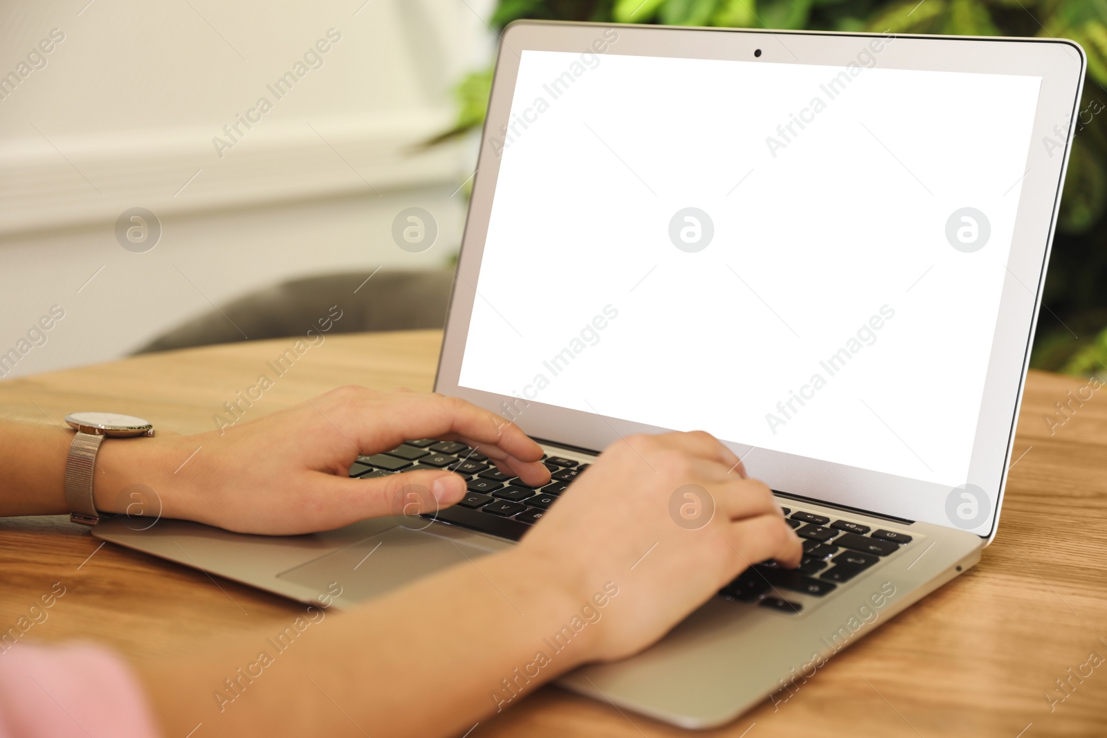 Image of Young woman using modern computer at table in office, closeup. Space for design