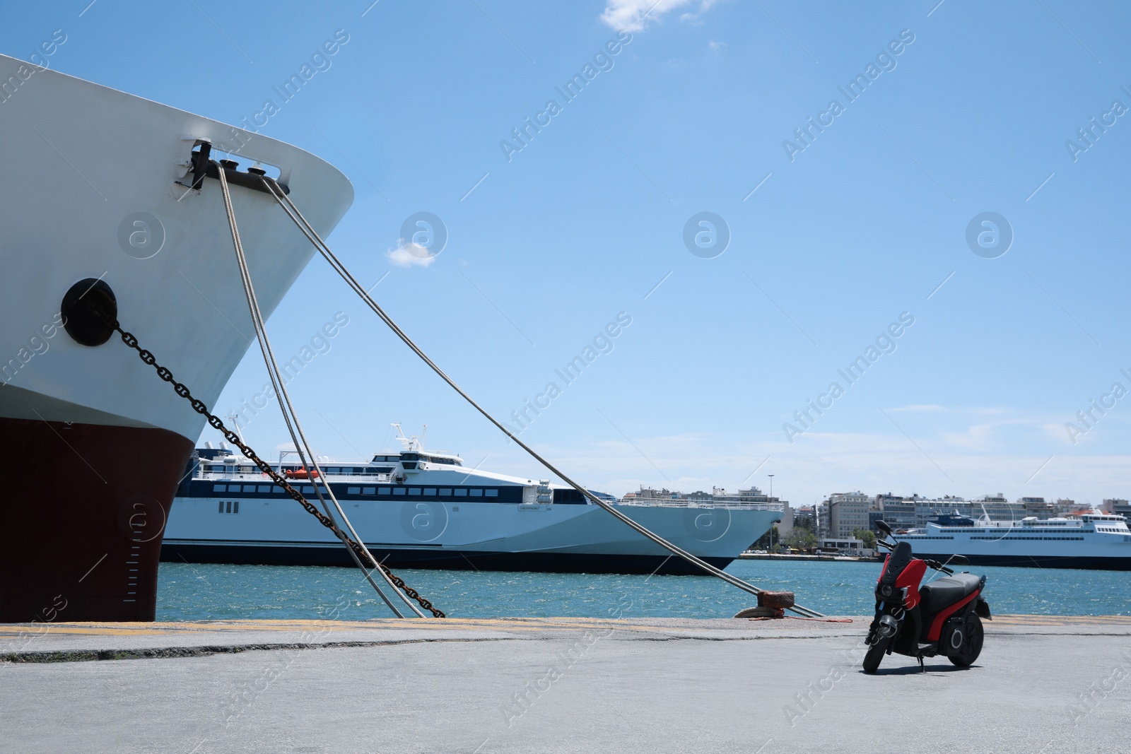 Photo of Modern ferry and scooter in sea port on sunny day