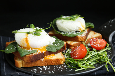 Photo of Delicious poached egg sandwiches served on slate board