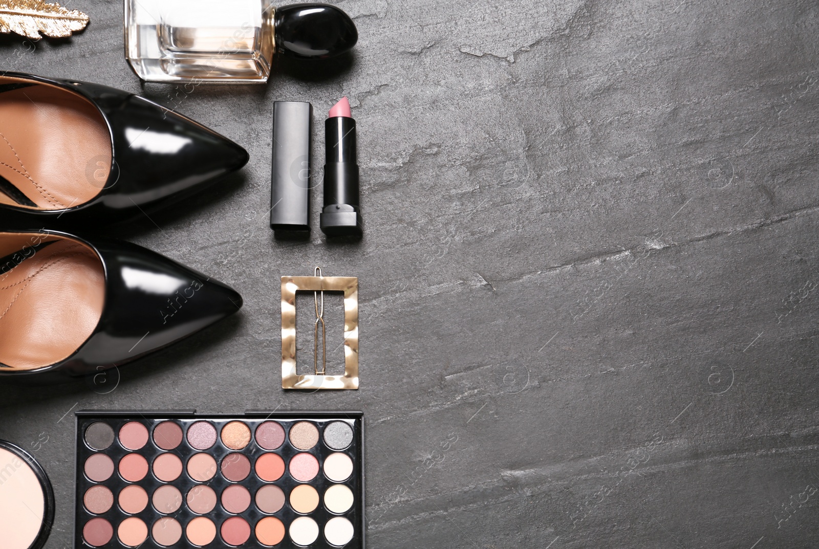 Photo of Flat lay composition with stylish women's shoes and cosmetic products on black background. Space for text