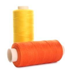 Photo of Different colorful sewing threads on white background