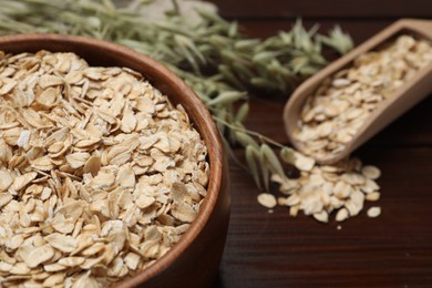 Photo of Bowl with oatmeal on table, closeup. Space for text