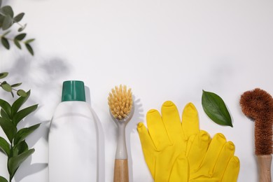 Photo of Flat lay composition with different cleaning supplies on white background, space for text