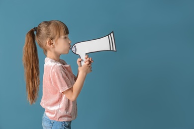 Cute little girl with paper megaphone on color background