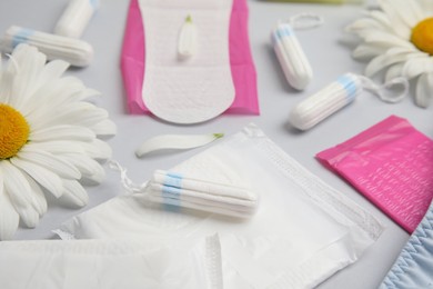 Tampons and other menstrual hygienic products on white marble background