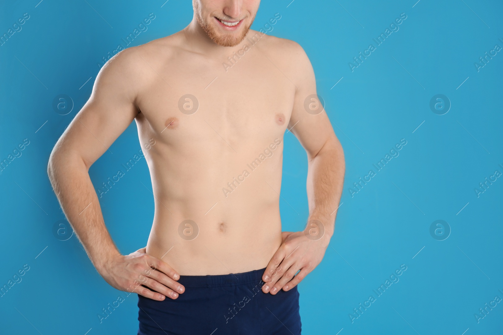 Photo of Man with slim body on color background, closeup