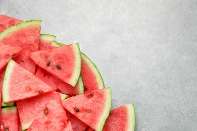 Photo of Slices of tasty ripe watermelon on light grey table, flat lay. Space for text