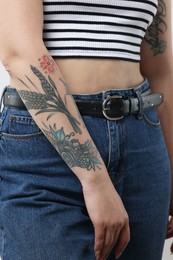 Woman in jeans with cool tattoos, closeup view