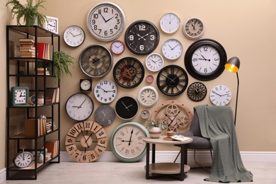 Photo of Stylish room interior with collection of wall clocks