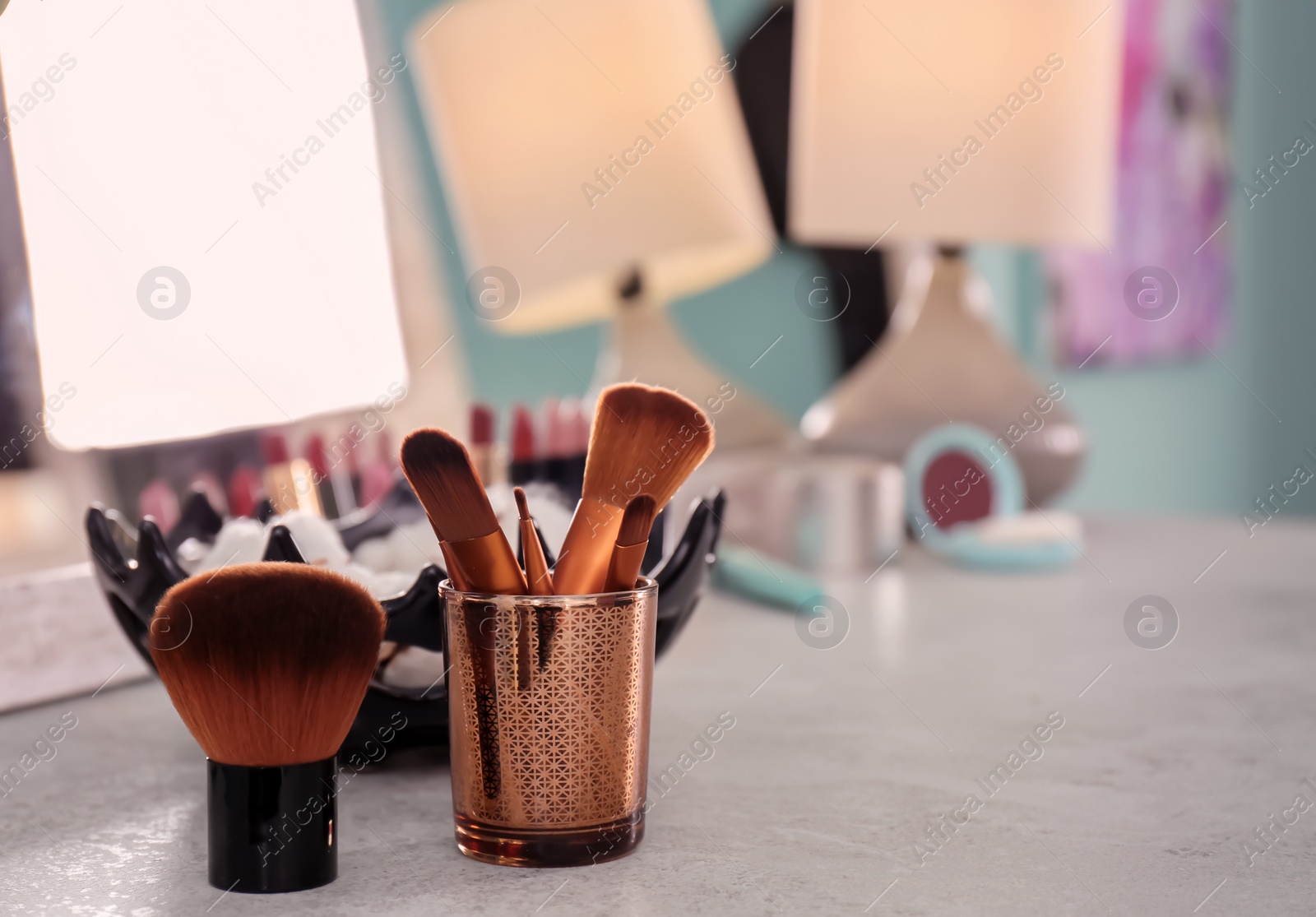 Photo of Brushes on dressing table in makeup room, closeup