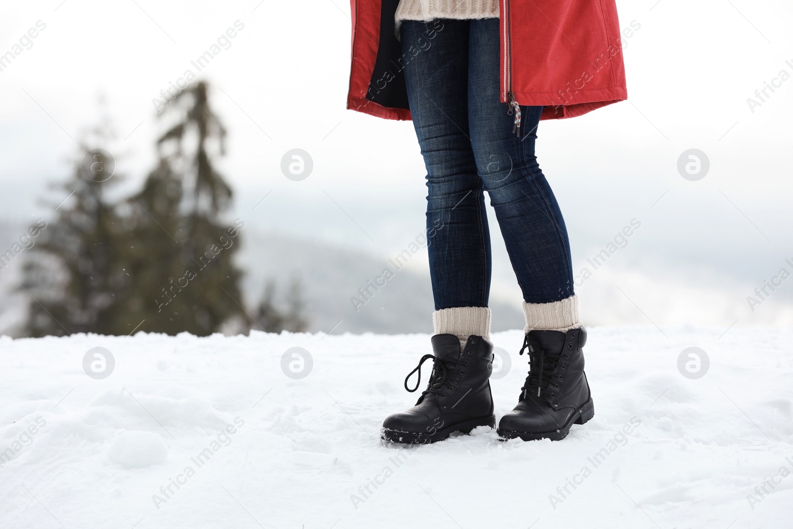 Photo of Woman walking outdoors on snowy day, closeup with space for text. Winter vacation