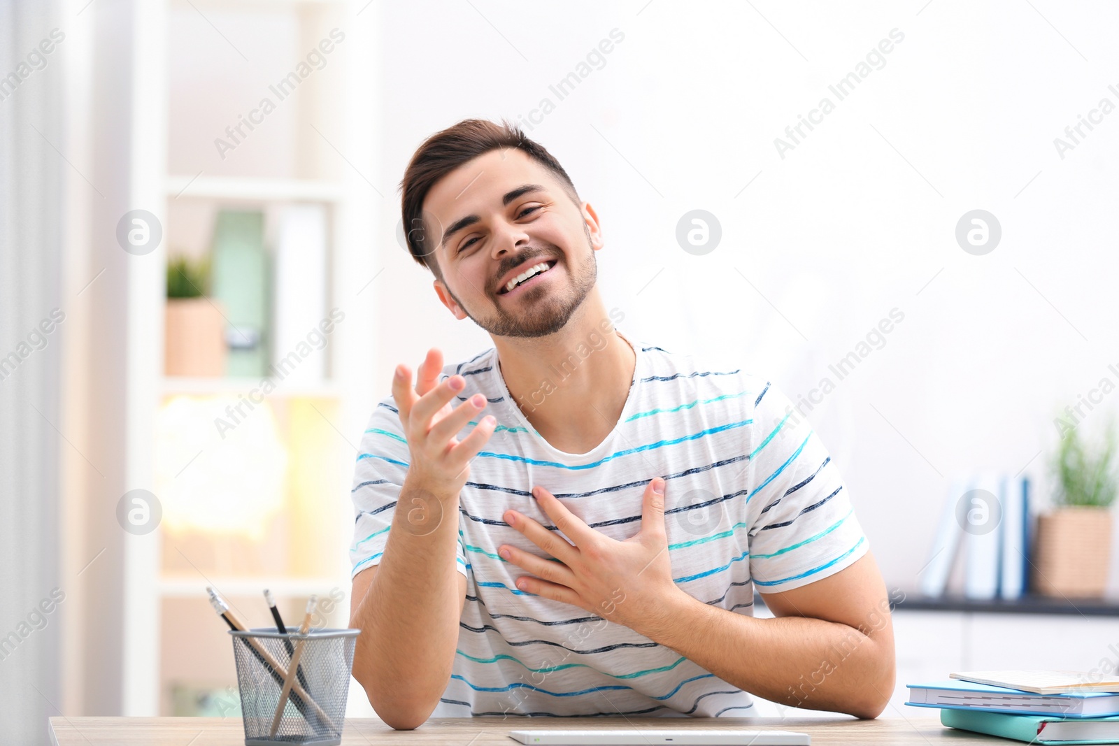 Photo of Handsome man using video chat for conversation indoors