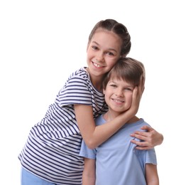 Happy brother and sister hugging on white background