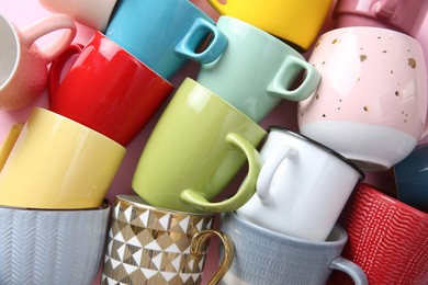 Many different cups on pink background, flat lay. Diversity concept