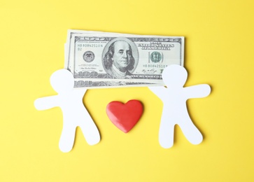 Photo of Paper silhouettes of people with money and heart on color background, top view. Life insurance concept