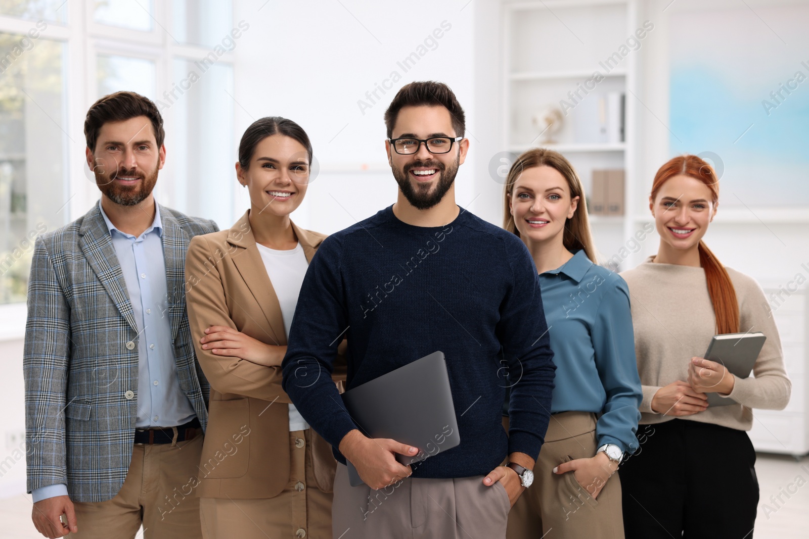 Photo of Portrait of happy employees in office. Team work
