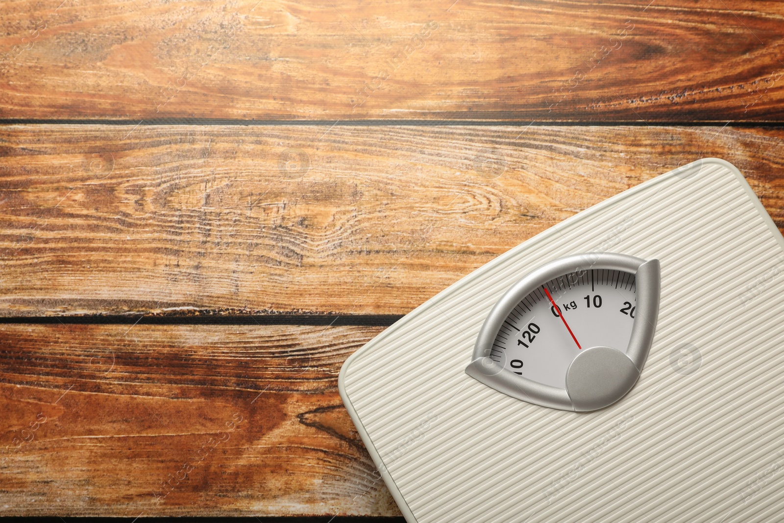 Photo of Weigh scales on wooden table, top view with space for text. Overweight concept