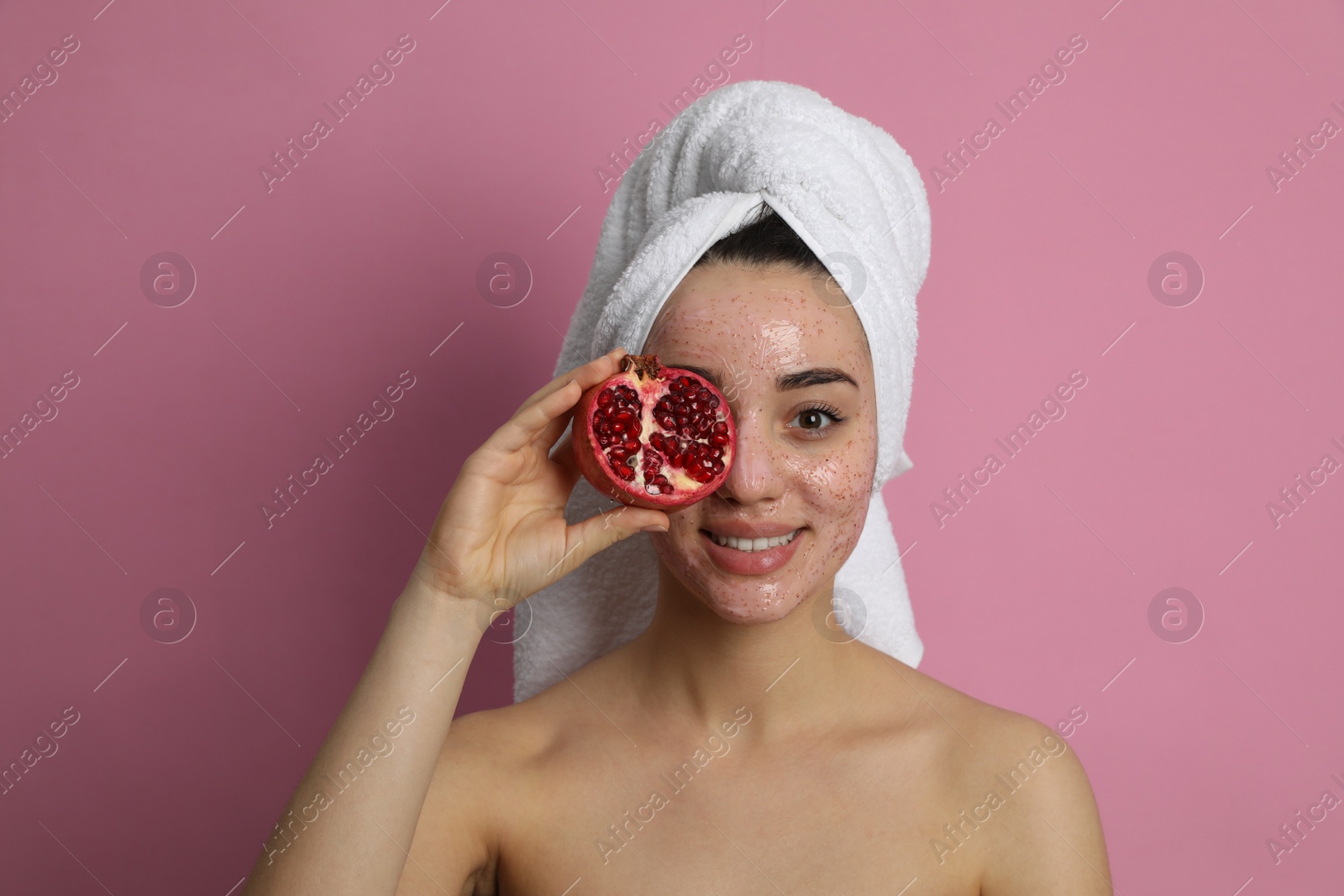 Photo of Woman with pomegranate face mask and fresh fruit on pink background