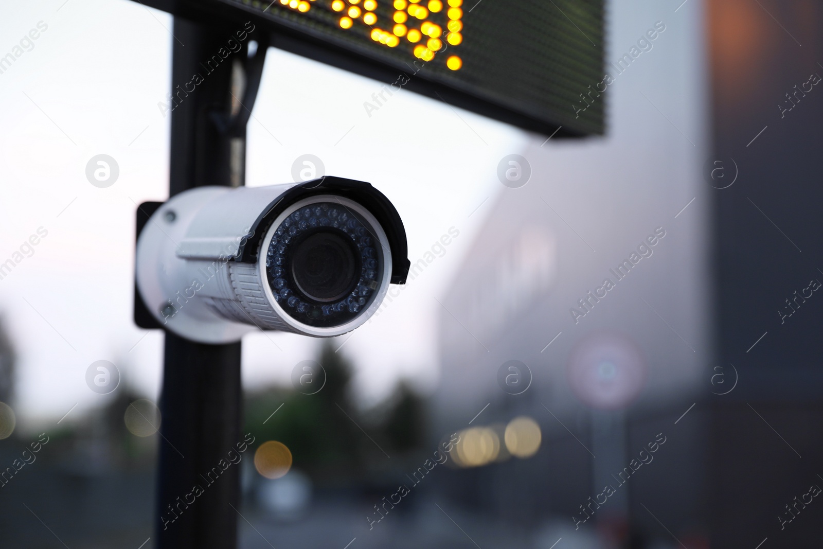 Photo of Modern CCTV security camera on street, closeup. Space for text