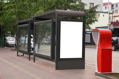 Photo of Blank advertising board on transport stop. Space for design